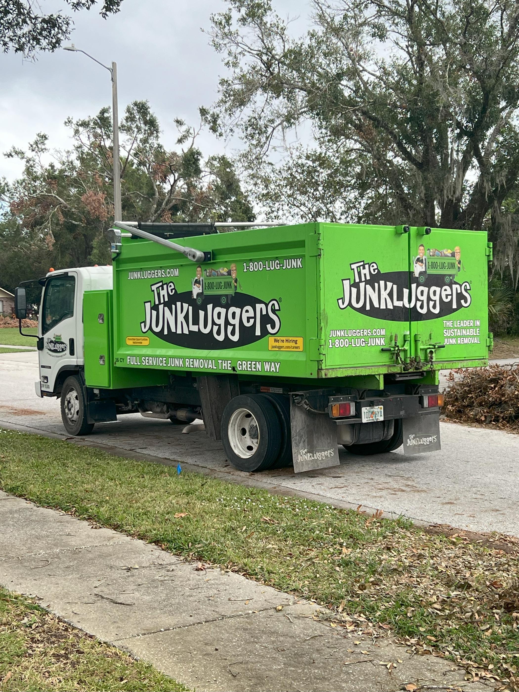 Junkluggers vehicle ready for eco-friendly junk pickup in a neighborhood