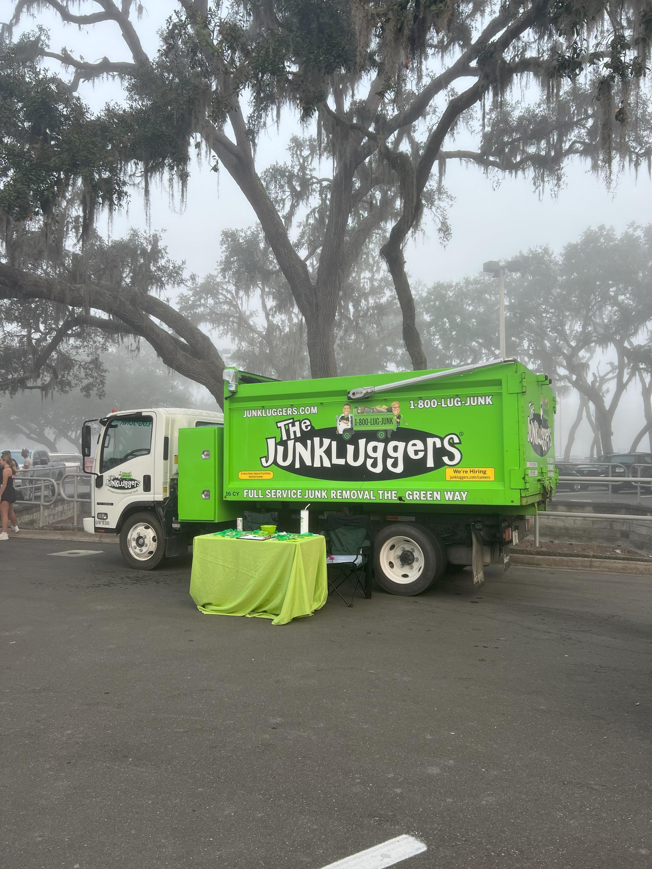 Our Junkluggers truck with green table setup in front on a foggy street