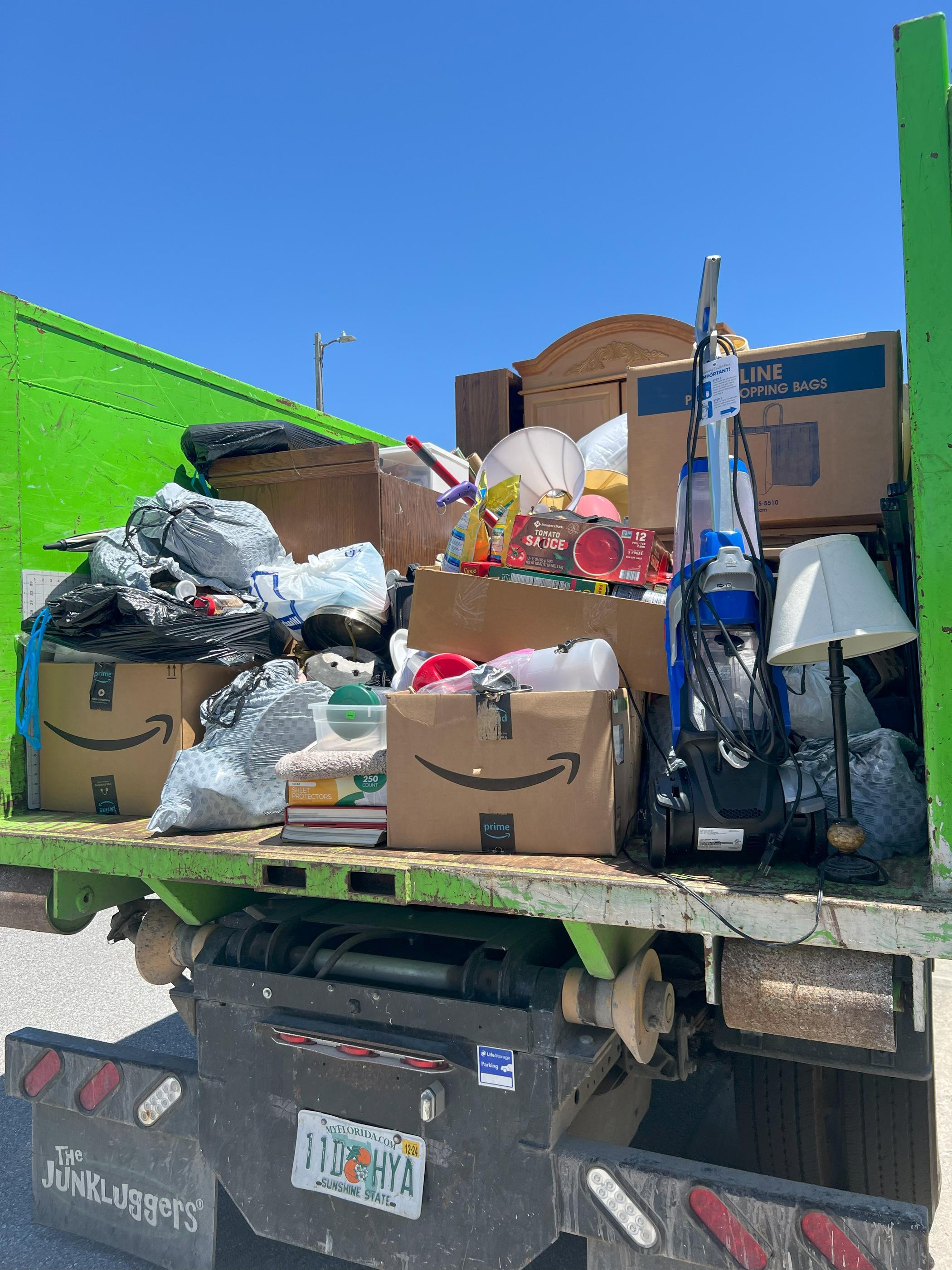 The JunkLuggers truck filled with various discarded items