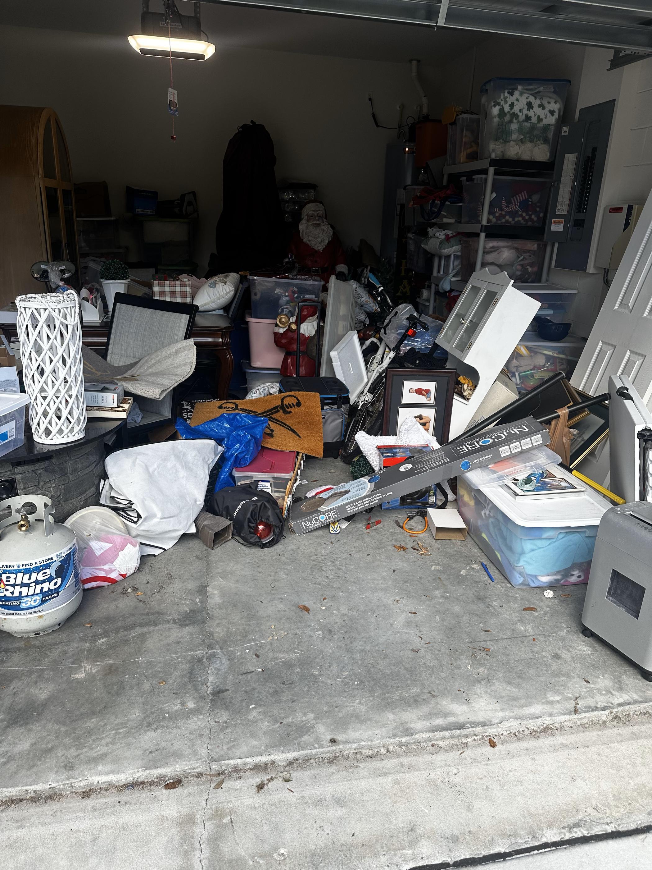 A cluttered garage filled with unused and stored items