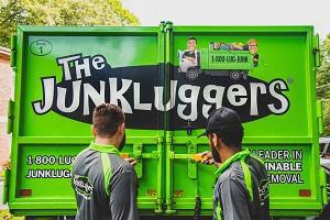 team members closing up junkluggers truck
