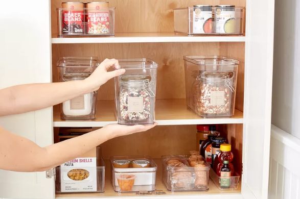 hands placing an item into a pantry