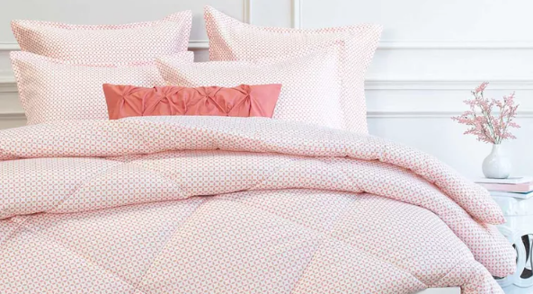 pink patterned bed with white walls