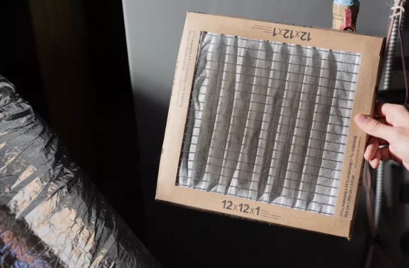 hand holding dirty air filter