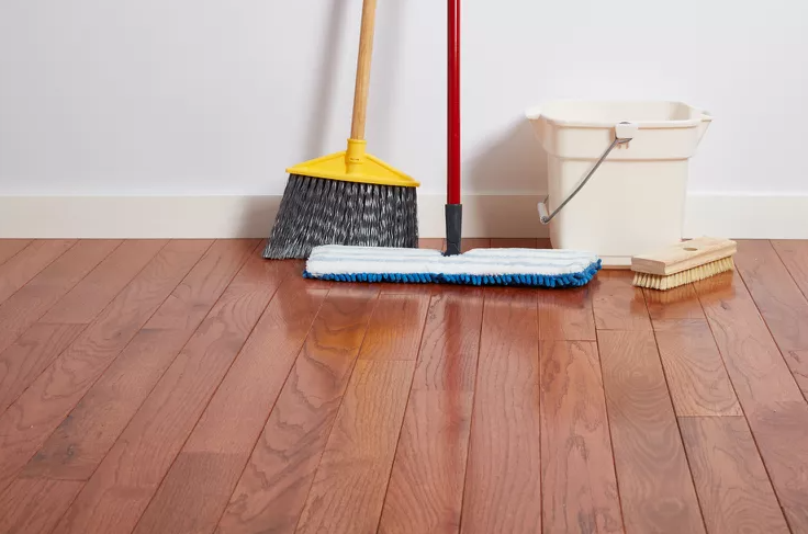 mop, broom and bucket with scrubber on hard wood floor