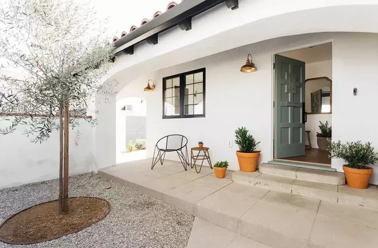 one story white house with open light green door